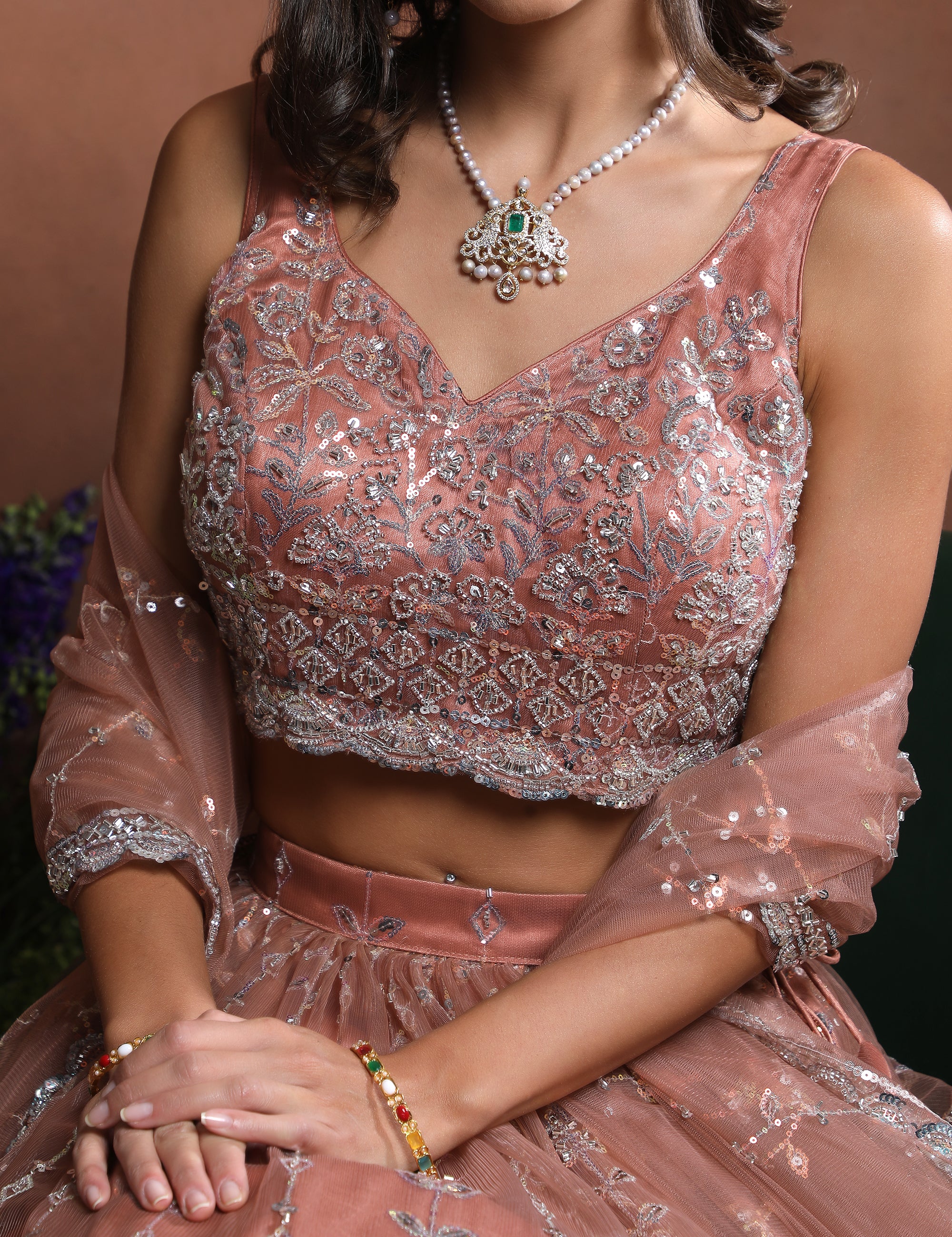 Sleeveless Peach Sparkle Embroidered Net Lehenga