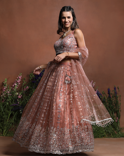 Sleeveless Peach Sparkle Embroidered Net Lehenga